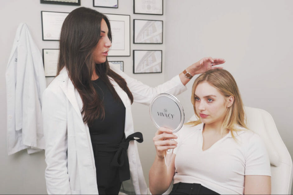 Medical nurse injector explains platelet rich plasma therapy to patient.